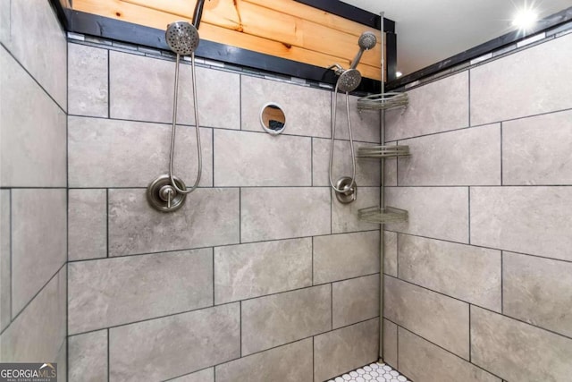 bathroom with tiled shower