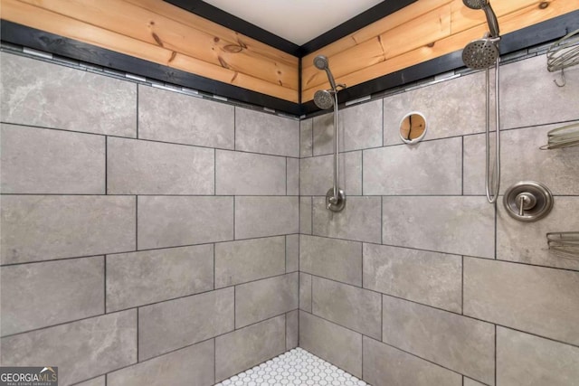 bathroom with a tile shower