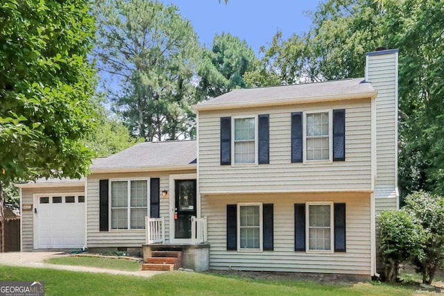 split level home featuring a front yard and a garage