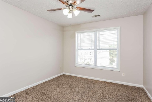 carpeted empty room with a textured ceiling and ceiling fan