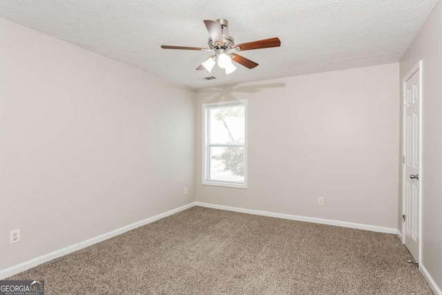 carpeted spare room with a textured ceiling and ceiling fan