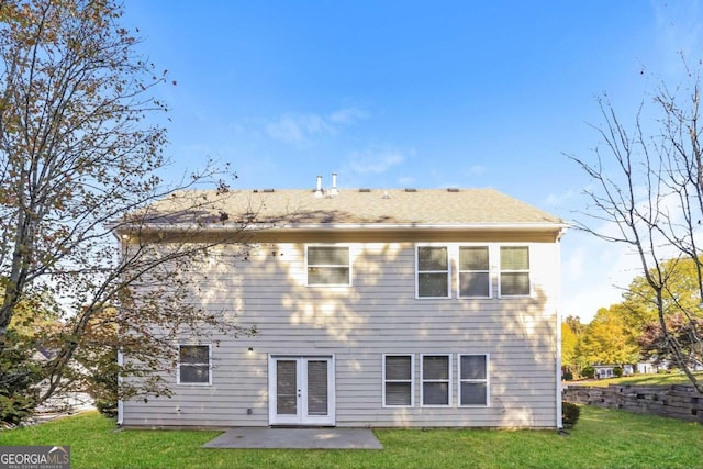 back of property with french doors, a patio area, and a lawn