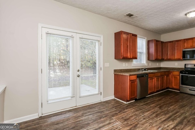 kitchen featuring appliances with stainless steel finishes, dark hardwood / wood-style floors, and a wealth of natural light