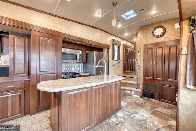 kitchen with pendant lighting, a center island with sink, stainless steel appliances, ornamental molding, and light stone countertops