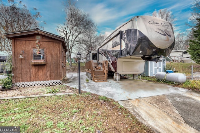 exterior space featuring an outdoor structure and a shed