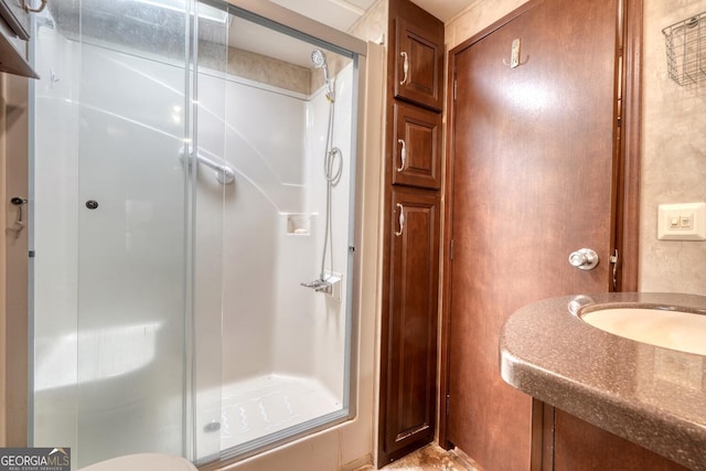 bathroom with sink and a shower with door