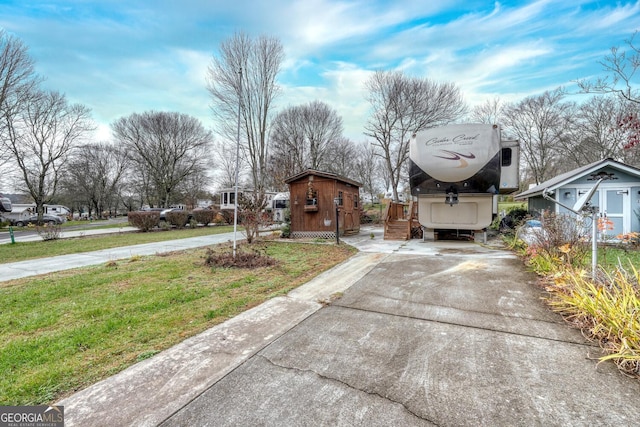 view of road with concrete driveway