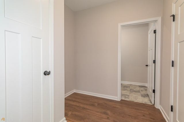 hallway with dark hardwood / wood-style flooring