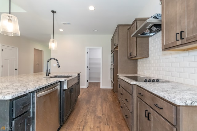 kitchen featuring hardwood / wood-style flooring, decorative light fixtures, sink, and appliances with stainless steel finishes