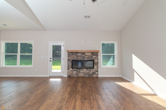 unfurnished living room featuring ceiling fan, dark hardwood / wood-style flooring, a fireplace, and vaulted ceiling