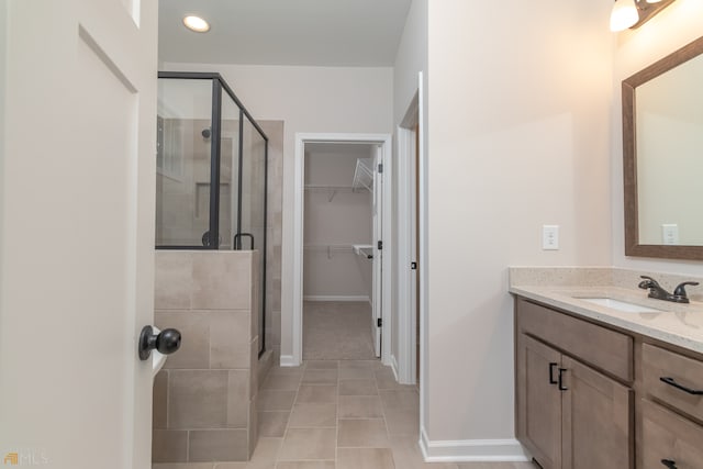 bathroom with tile patterned flooring, vanity, and an enclosed shower