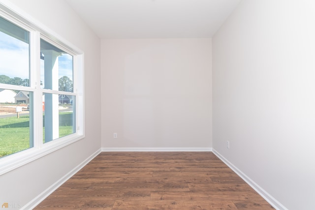 unfurnished room featuring dark hardwood / wood-style flooring