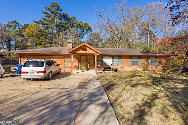 ranch-style home featuring a front yard and a garage