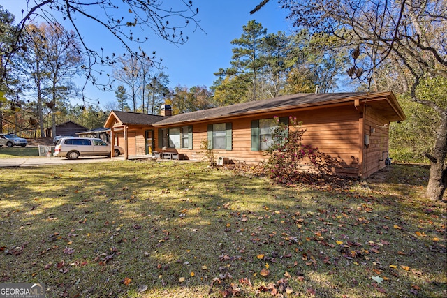 single story home with a garage and a front lawn