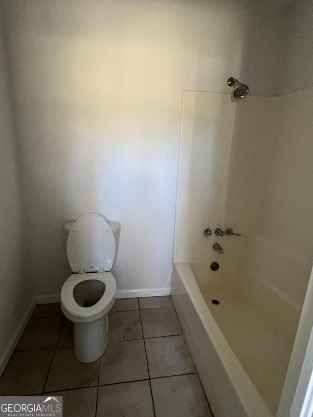 bathroom with tile patterned flooring, toilet, and shower / bathtub combination