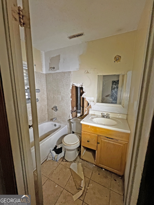 bathroom with a tub to relax in, tile patterned flooring, vanity, and toilet