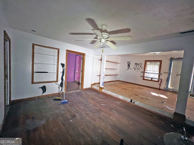 unfurnished living room featuring hardwood / wood-style flooring and ceiling fan