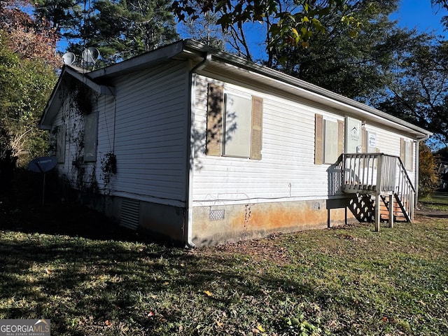 view of property exterior with a yard