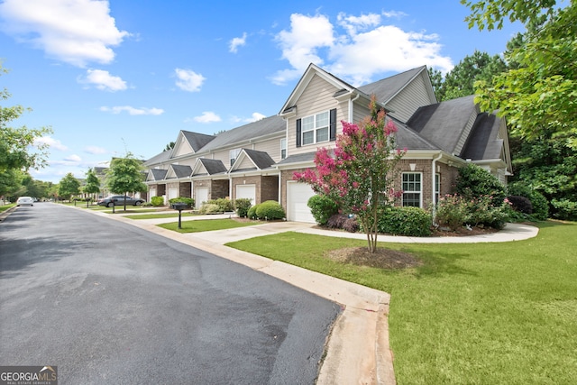 view of front of property with a front yard and a garage