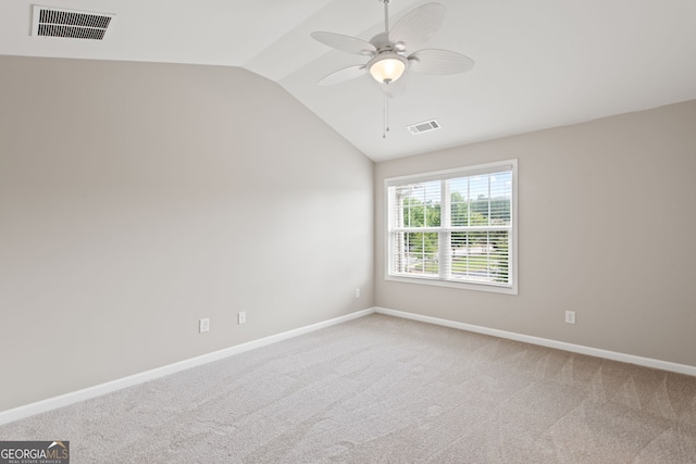 carpeted spare room featuring ceiling fan and lofted ceiling