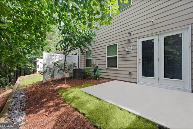 view of yard with central AC unit and a patio area