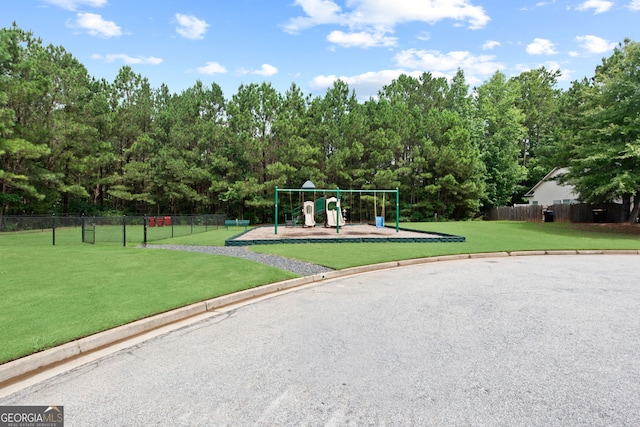 view of playground with a lawn