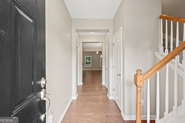 corridor with wood-type flooring