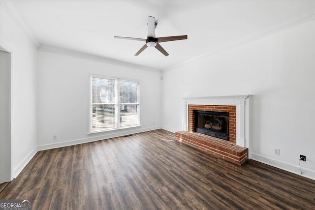 unfurnished living room with crown molding, dark hardwood / wood-style floors, ceiling fan, and a fireplace