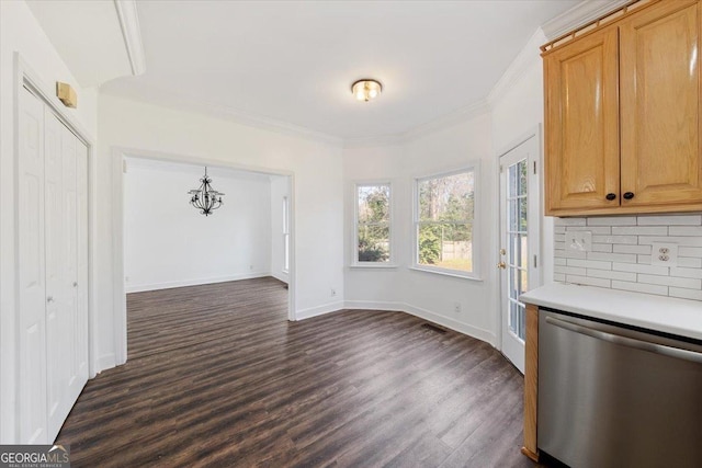 unfurnished dining area with crown molding, dark hardwood / wood-style flooring, and a chandelier