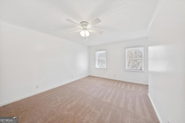 unfurnished room featuring crown molding, ceiling fan, and light carpet