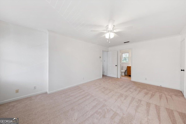 carpeted spare room with crown molding and ceiling fan