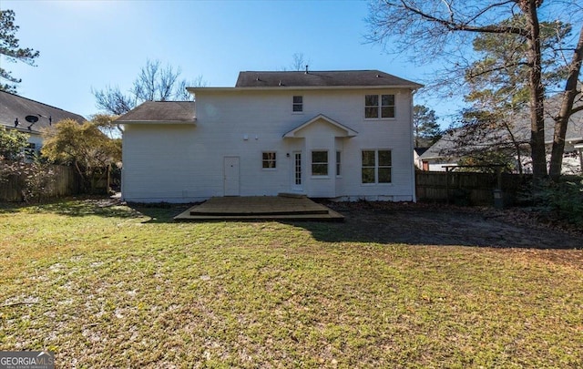 back of house featuring a lawn