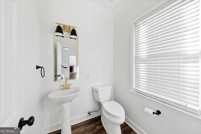 bathroom with ornamental molding, toilet, and wood-type flooring