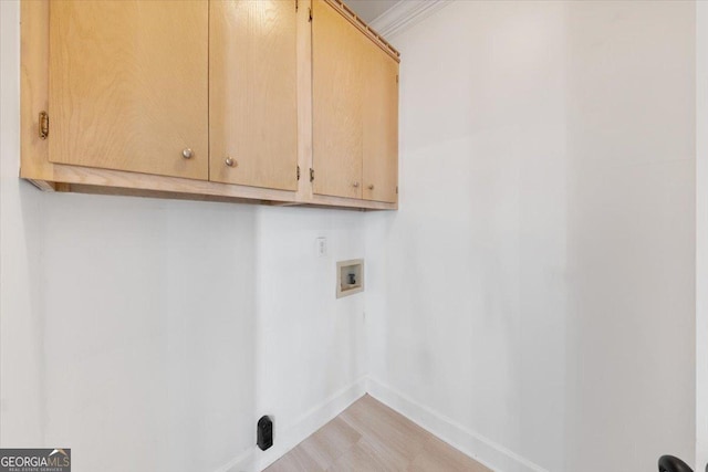 laundry room with cabinets, washer hookup, and ornamental molding