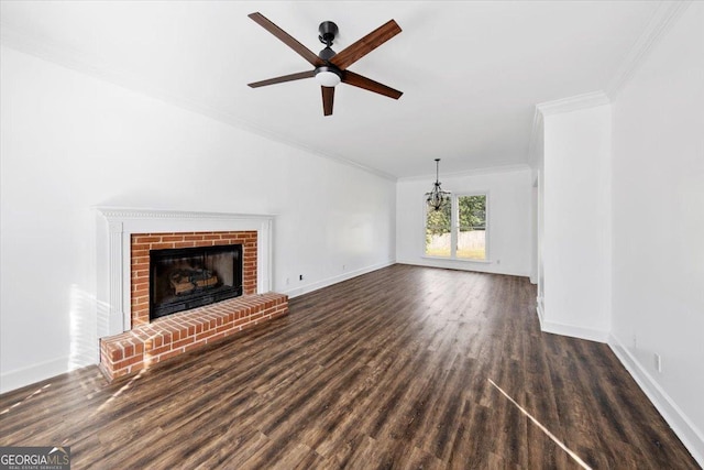 unfurnished living room featuring dark hardwood / wood-style flooring, a fireplace, ornamental molding, and ceiling fan