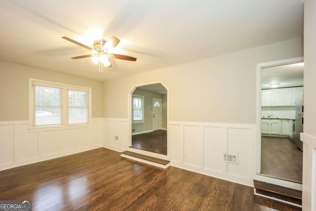 spare room featuring ceiling fan and dark wood-type flooring