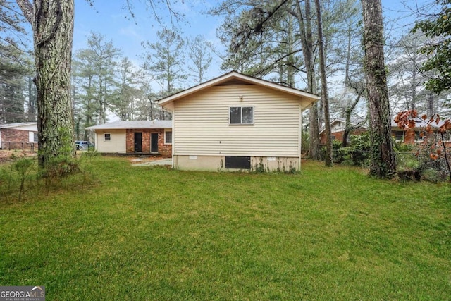 back of house with a lawn