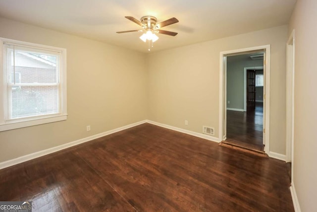 unfurnished room with dark hardwood / wood-style floors and ceiling fan