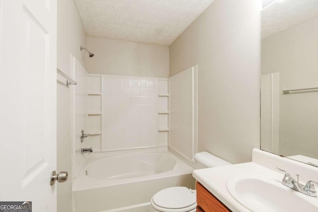 full bathroom featuring vanity, shower / bathing tub combination, a textured ceiling, and toilet