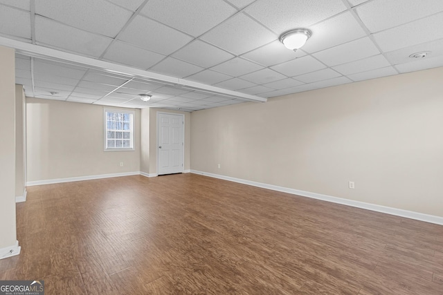 basement featuring hardwood / wood-style flooring and a paneled ceiling