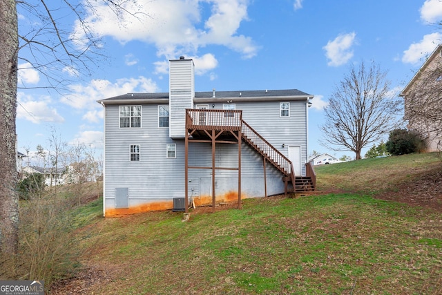 back of house with a yard, cooling unit, and a deck