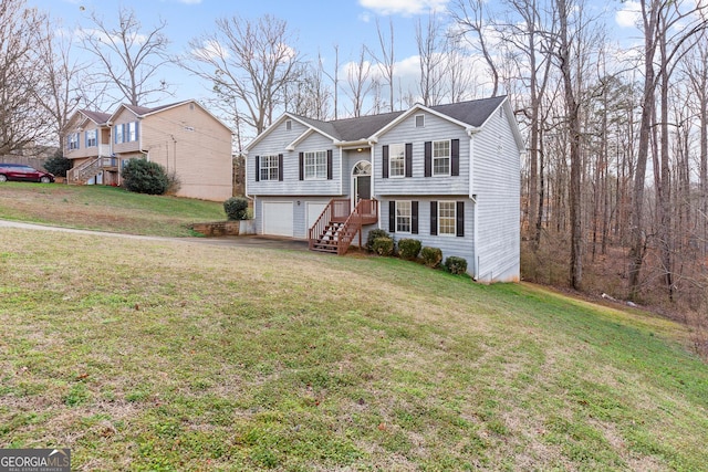 bi-level home with a garage and a front yard