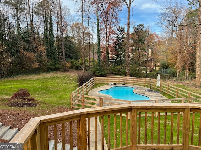 view of pool with a lawn