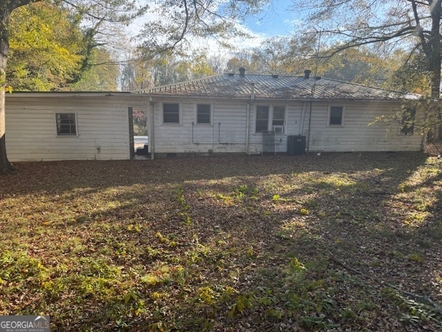 rear view of house with cooling unit