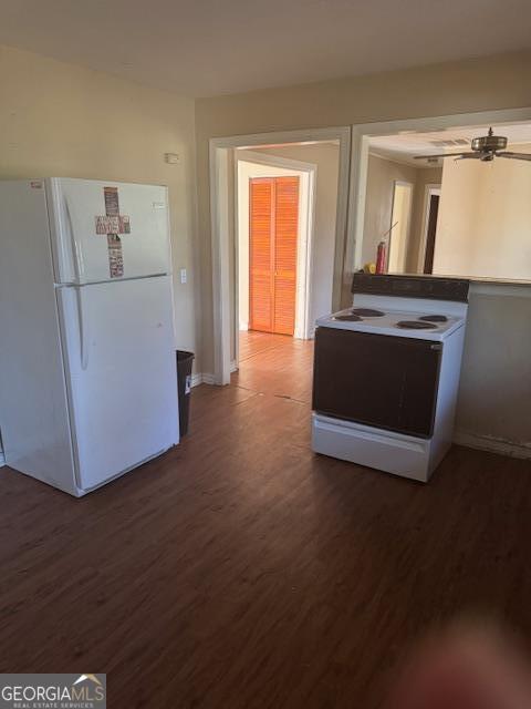 kitchen with ceiling fan, white appliances, and dark wood-type flooring