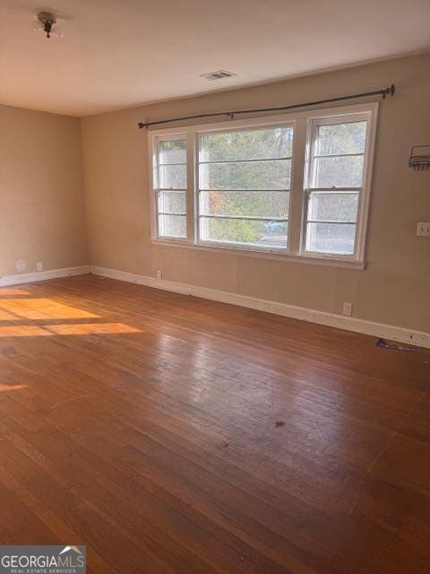 empty room with hardwood / wood-style floors