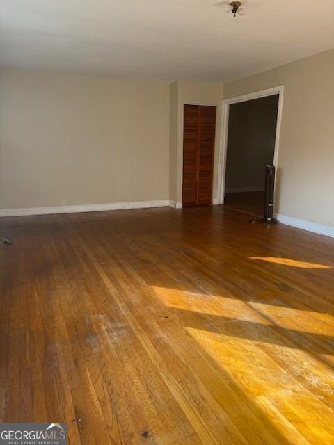 spare room with dark hardwood / wood-style floors