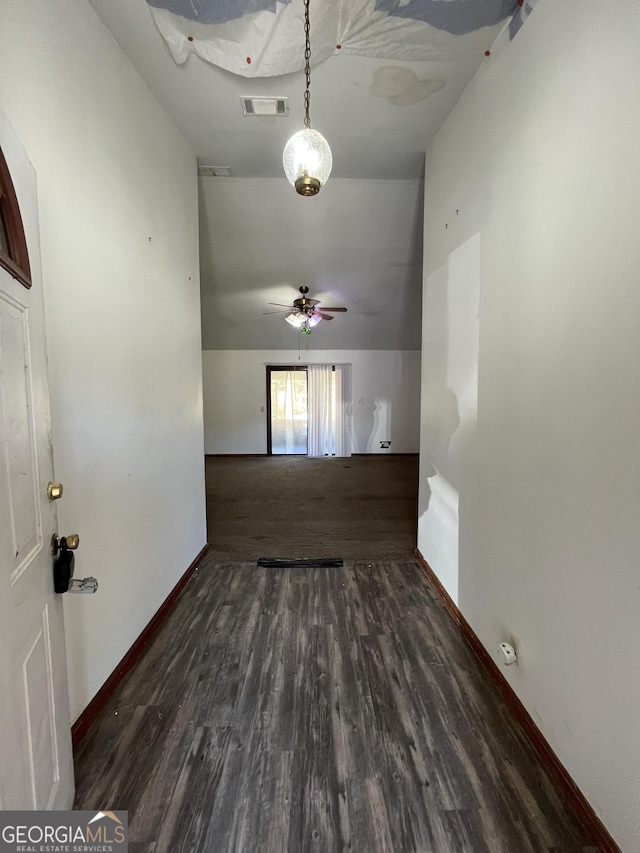 empty room with ceiling fan and dark hardwood / wood-style floors