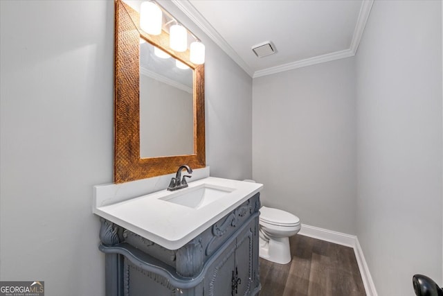 bathroom with crown molding, vanity, wood-type flooring, and toilet