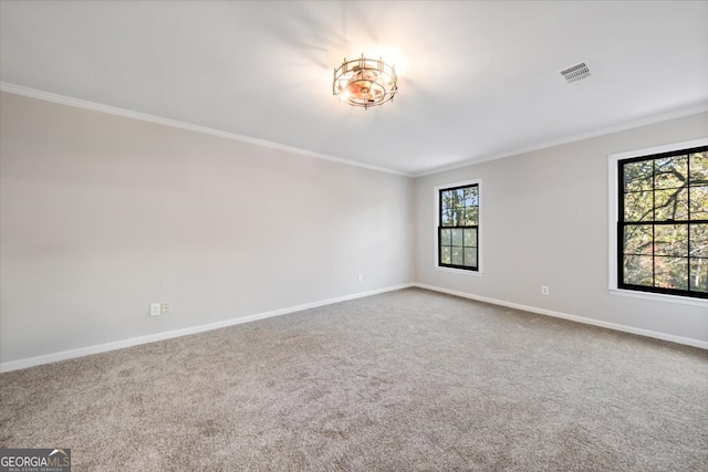 unfurnished room with carpet flooring, a notable chandelier, and ornamental molding